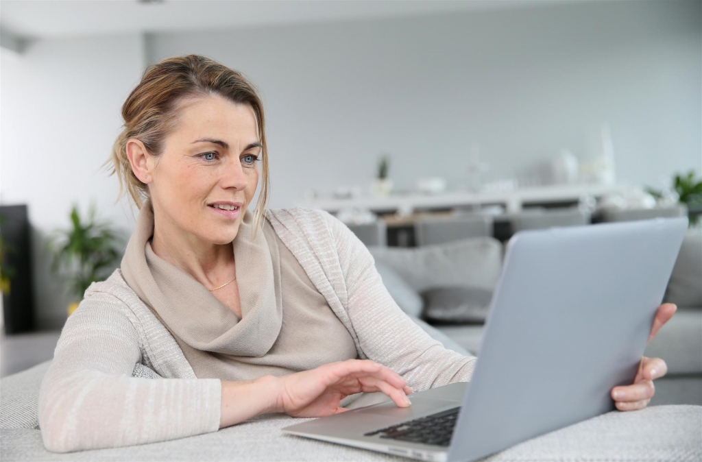 woman doing research on ui on laptop